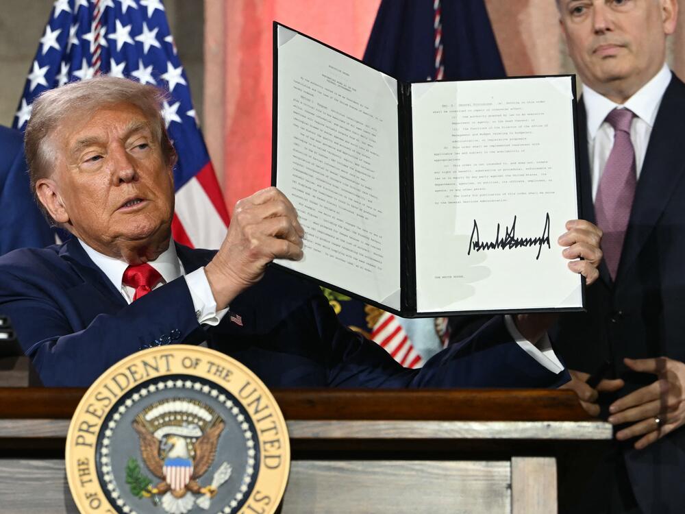 President Trump displays an executive order on artificial intelligence he signed in Washington, DC, on July 23, 2025.