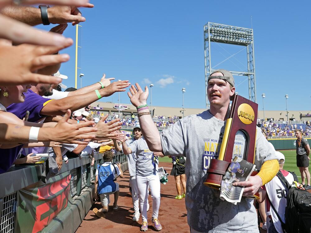 Jared Jones of the LSU Tigers celebrates with fans after defeating the Coastal Carolina Chanticleers to win the NCAA College World Series baseball finals last month in Omaha, Neb.