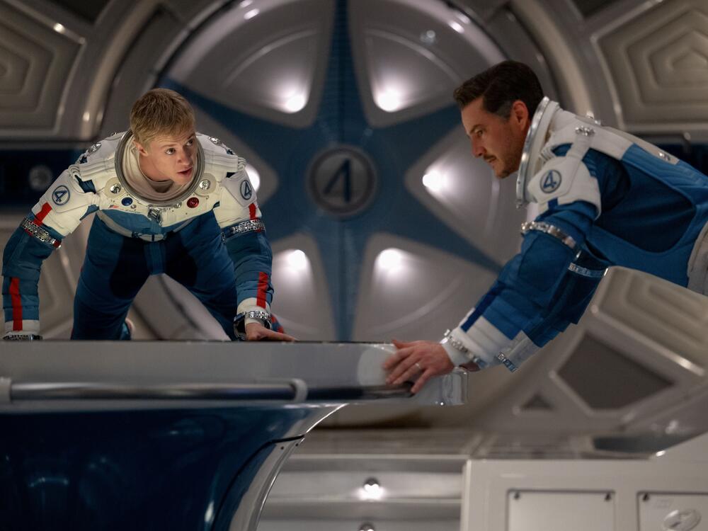 Joseph Quinn as Johnny Storm (Human Torch) and Pedro Pascal as Reed Richards (Mister Fantastic) in <em>The Fantastic Four: First Steps. </em>