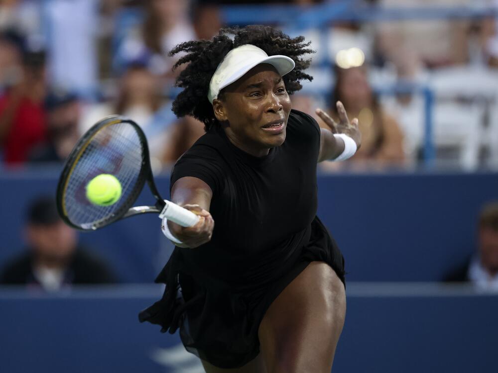 Venus Williams returns a shot against <a href=