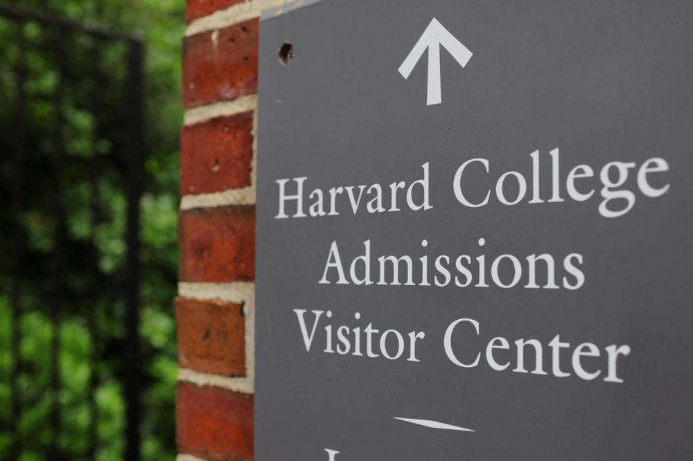 A sign points the way to the Harvard College Admissions Visitors Center at Harvard University in Cambridge, Massachusetts, U.S., July 6, 2023. REUTERS/Brian Snyder