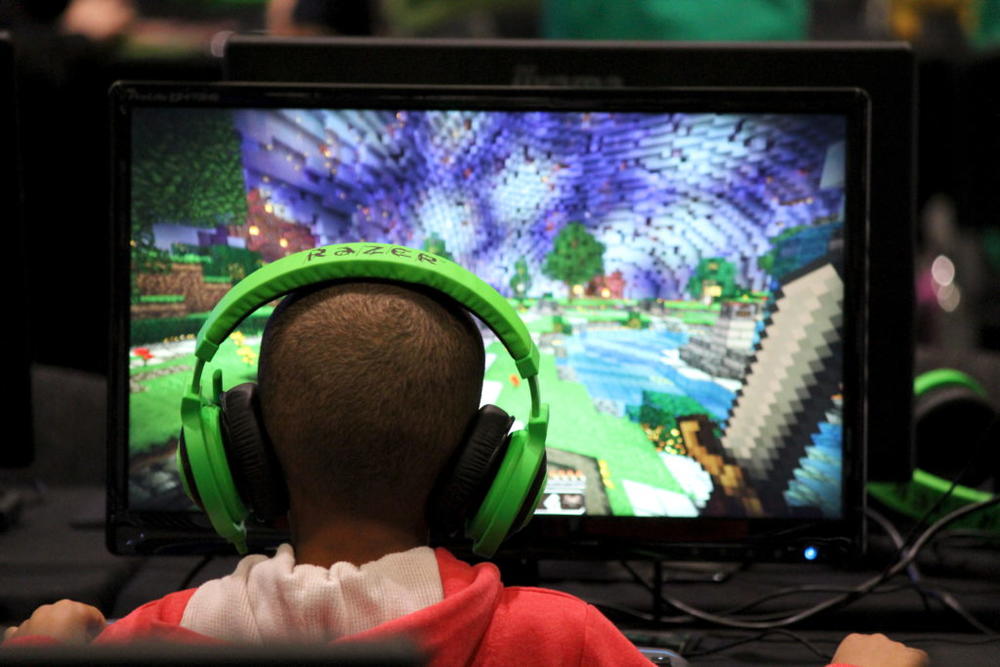 A child plays video game Minecraft at the Minecon convention in London Jul. 4, 2015. The 10,000 tickets sold for Minecon in London made it the largest ever convention for a single video game. Photo by Matthew Tostevin/Reuters.