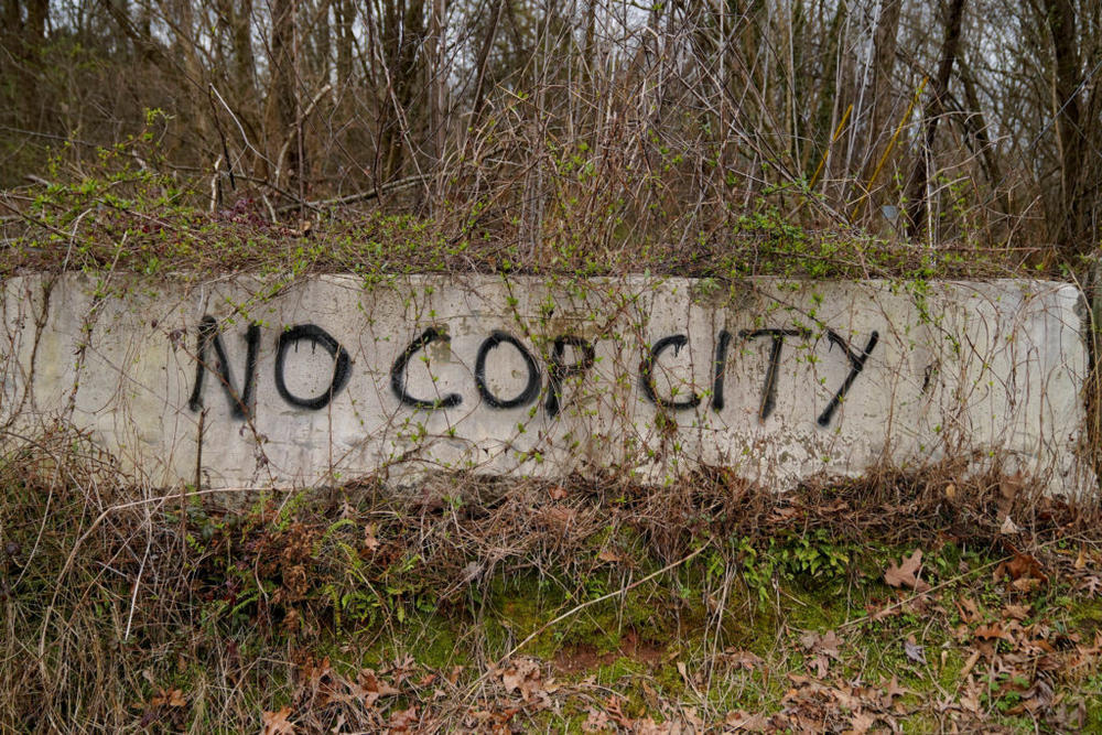 Graffiti is seen at the edge of Weelaunee People's Park, the planned site of a controversial "Cop City" project, days after protestor Tortuguita died during a police raid, near Atlanta, Georgia, Jan. 21, 2023. Photo by Cheney Orr/REUTERS