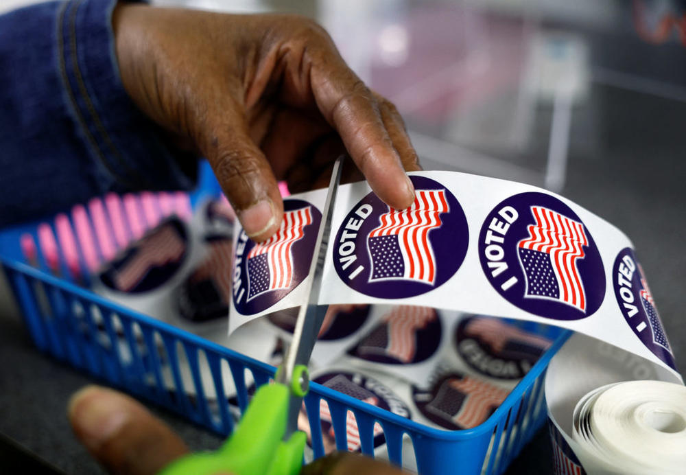 A poll worker prepares "I voted" stickers for voters at the City Clerk's Office ahead of the midterm election in Lansing, Michigan, U.S., November 7, 2022. Photo by Evelyn Hockstein/REUTERS