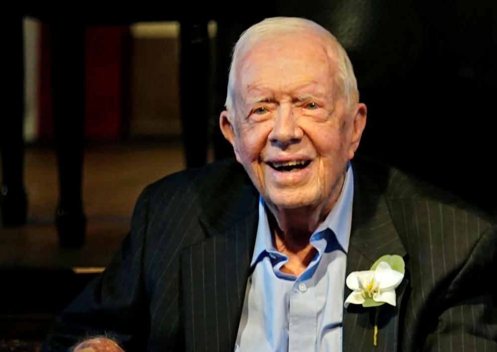 Former President Jimmy Carter smiles as his wife, former first lady Rosalynn Carter, speaks during a reception to celebrate their 75th wedding anniversary in Plains, Georgia, July 10, 2021. Photo by John Bazemore/Pool via REUTERS