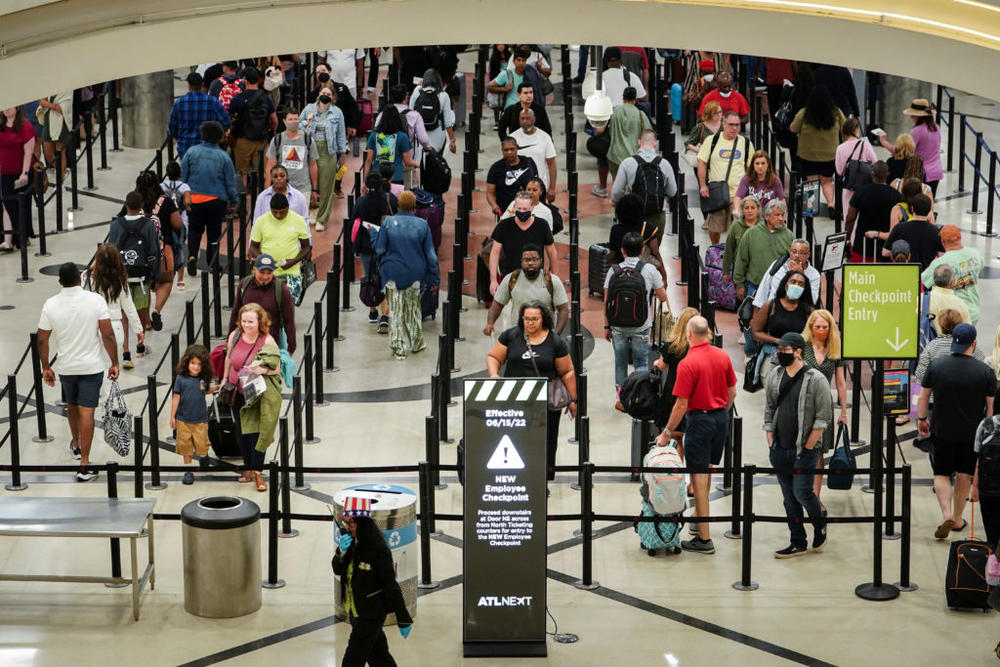 Passengers enter a security checkpoint before their flights at Hartsfield-Jackson Atlanta International Airport ahead of the Fourth of July holiday in Atlanta, Georgia, U.S., July 1, 2022. Photo by Elijah Nouvelage/Reuters.