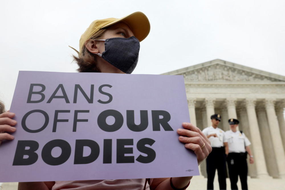 A demonstrator holds a sign during a protest outside the U.S. Supreme Court, after the leak of a draft majority opinion written by Justice Samuel Alito preparing for a majority of the court to overturn the landmark Roe v. Wade abortion rights decision later this year, in Washington, U.S., May 3, 2022. Photo by Evelyn Hockstein/REUTERS