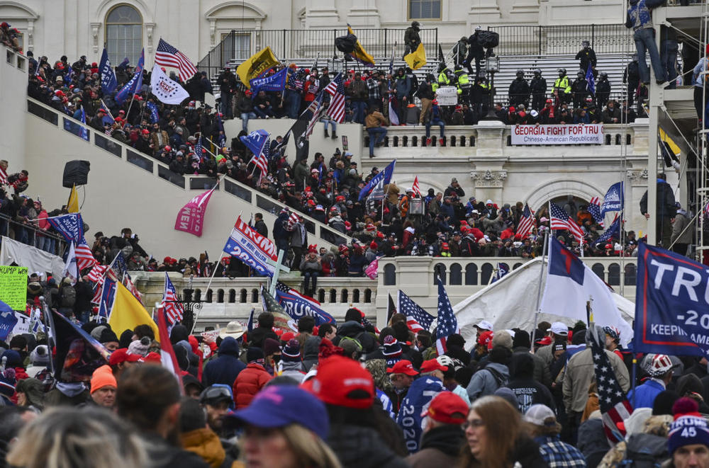 WASHINGTON, DC - JANUARY 6: Protesters take over the Inaugural stage during a protest calling for legislators to overturn the election results in President Donald Trump's favor at the U.S. Capitol on January 6, 2021 in Washington, D.C. (Photo by Ricky Carioti/The Washington Post via Getty Images)