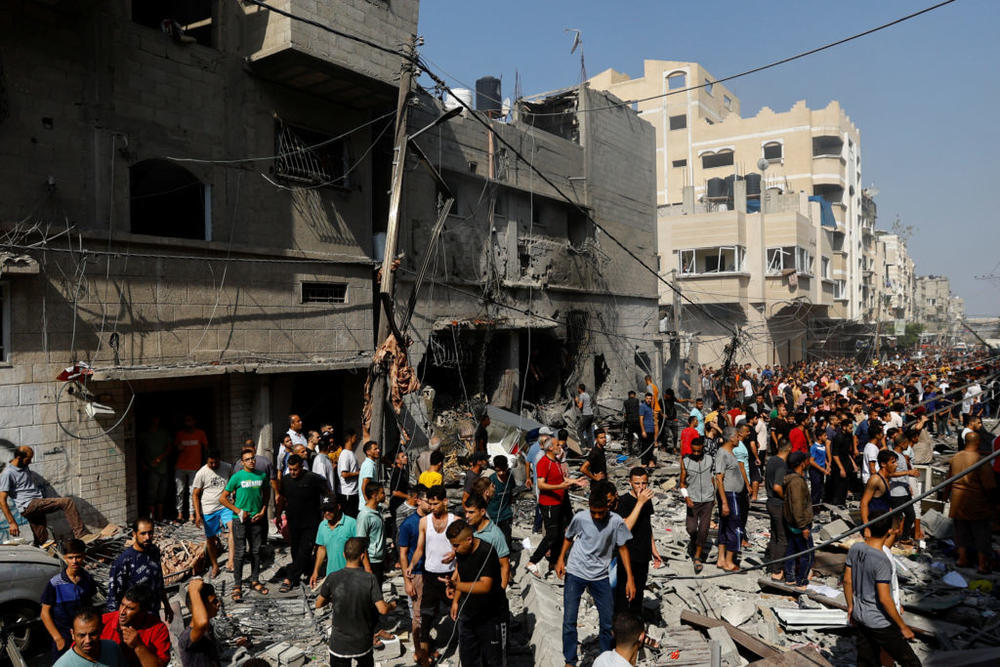 People gather at the site of an Israeli strike on a house, in Khan Younis, in the southern Gaza Strip, October 24, 2023. Ibraheem Abu Mustafa/Reuters