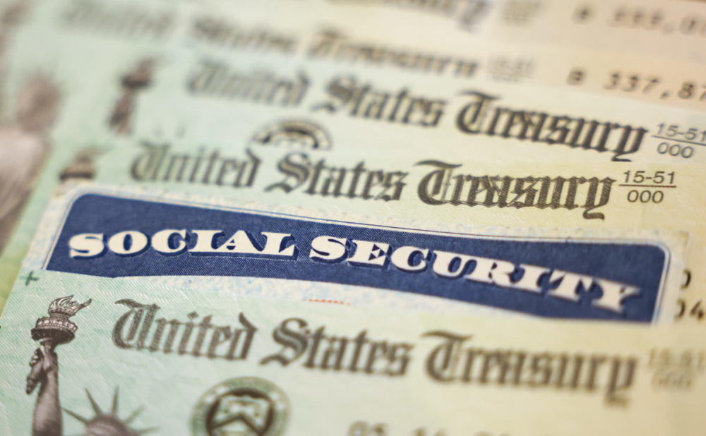 WASHINGTON, DC - OCTOBER 14: In this photo illustration, a Social Security card sits alongside checks from the U.S. Treasury on October 14, 2021 in Washington, DC. The Social Security Administration announced recipients will receive an annual cost of living adjustment of 5.9%, the largest increase since 1982. The larger increase is aimed at helping to offset rising inflation. Photo illustration by Kevin Dietsch/Getty Images