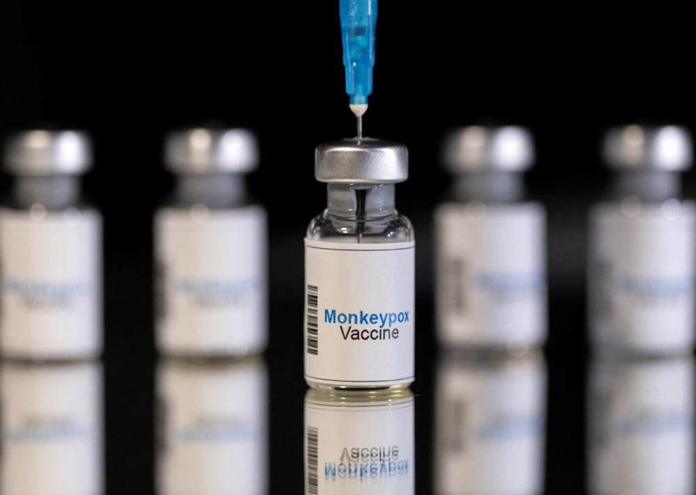 Mock-up vials labeled "Monkeypox vaccine" and medical syringe are seen in this illustration taken, May 25, 2022. REUTERS/Dado Ruvic/Illustration