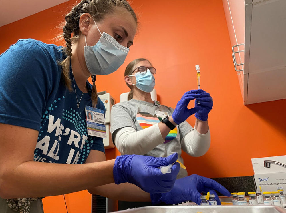 Dr. Emily Drwiega from the University of Illinois Health and Maggie Butler, a registered nurse, prepare monkeypox vaccines at the Test Positive Aware Network nonprofit clinic in Chicago, Illinois, U.S., July 25, 2022. REUTERS/Eric Cox