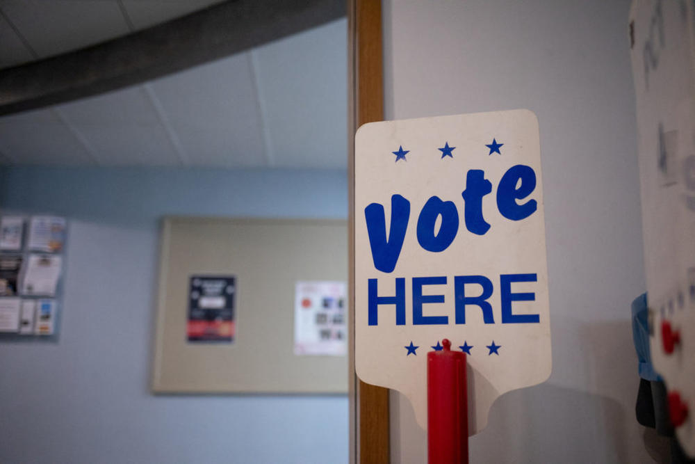 A 'Vote Here' sign is seen at a precinct the day before Michigan Democrats and Republicans choose their nominees to contest November's congressional elections, which will determine which party controls U.S. House of Representatives for next two years, in Birmingham, Michigan, U.S. August 1, 2022. REUTERS/Emily Elconin