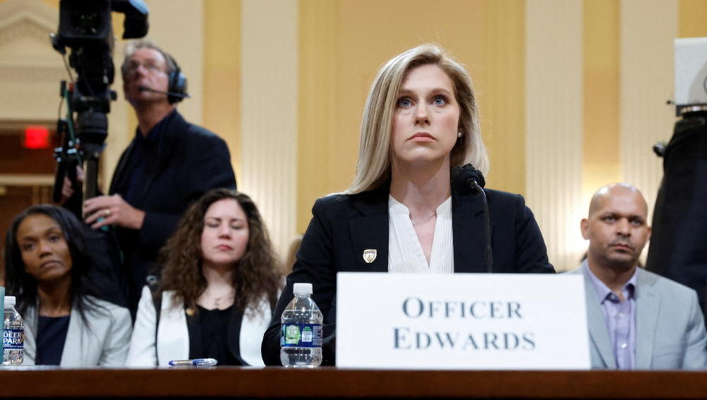 U.S. Capitol Police Officer Caroline Edwards testifies before the U.S. House Select Committee to Investigate the January 6 Attack on the United States Capitol with Sandra Garza, partner of Brian Sicknick, and U.S. Capitol Police Officer Sgt. Aquilino Gonell in the back, on Capitol Hill in Washington, U.S., June 9, 2022. Photo by Jonathan Ernst/REUTERS