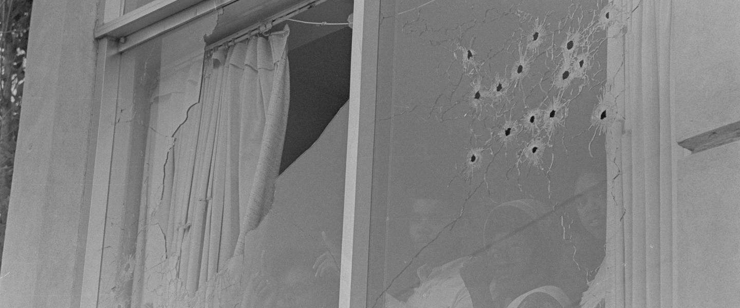Students peer out of the bullet-riddled windows of Alexander Hall, a women's dormitory at Jackson State College in Jackson, Miss., after two African-American students were killed and 12 injured when police opened fire on the building, claiming they were fired upon by snipers, May 15, 1970. The shooting occurred after rioting broke out on the campus.
