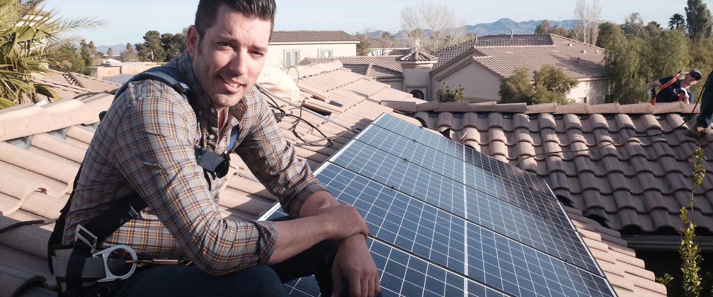 "Power Trip" director Jonathan Scott takes a break from installing solar panels on a rooftop.