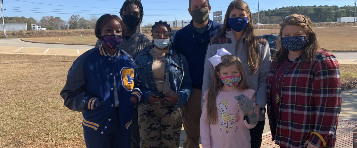 Students and teacher with prosthetic 