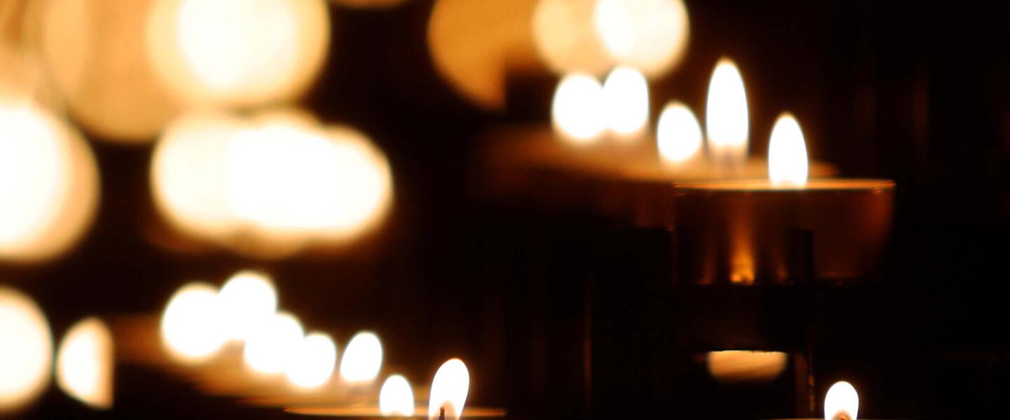 lit candles in a dark room