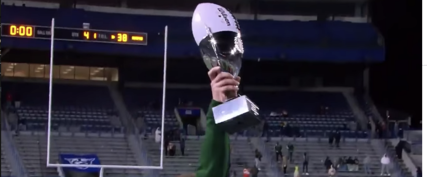 Adam Carter, coach of Grayson High School, holds the GHSA 2020 championship trophy for Class 7A.