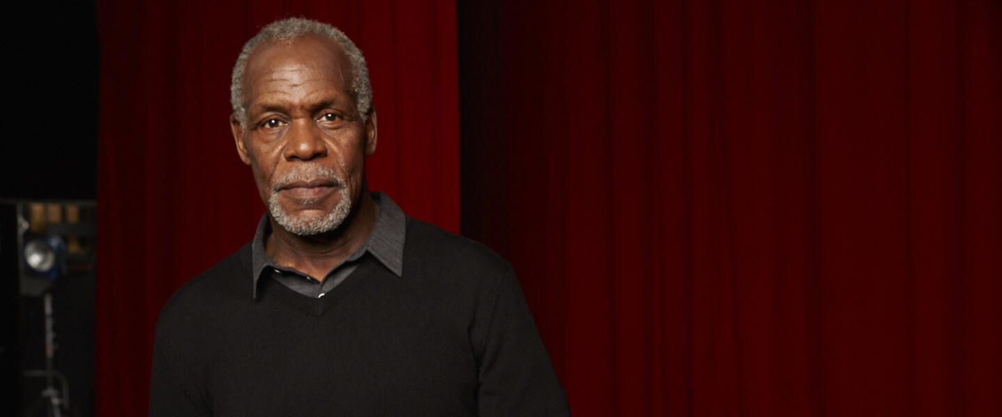Actor Danny Glover stands backstage.