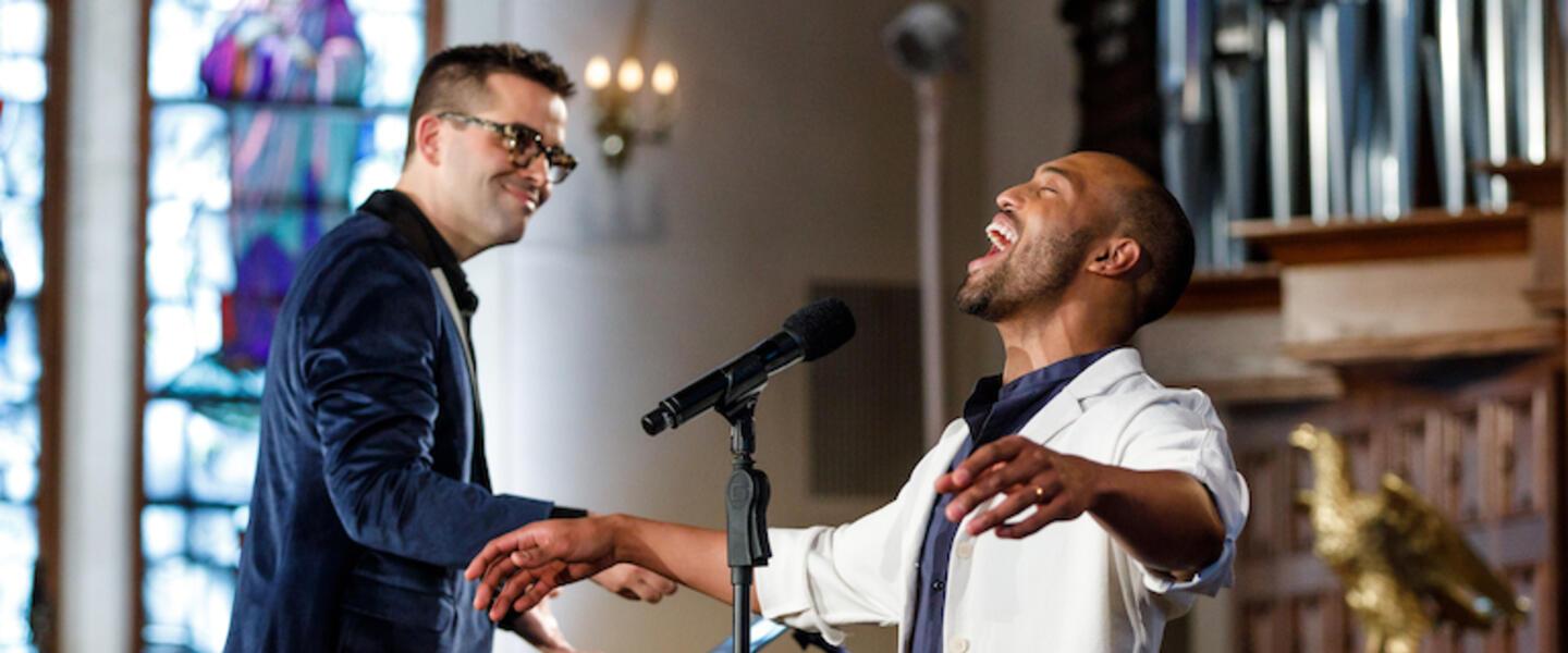 A conductor and singer in a church.