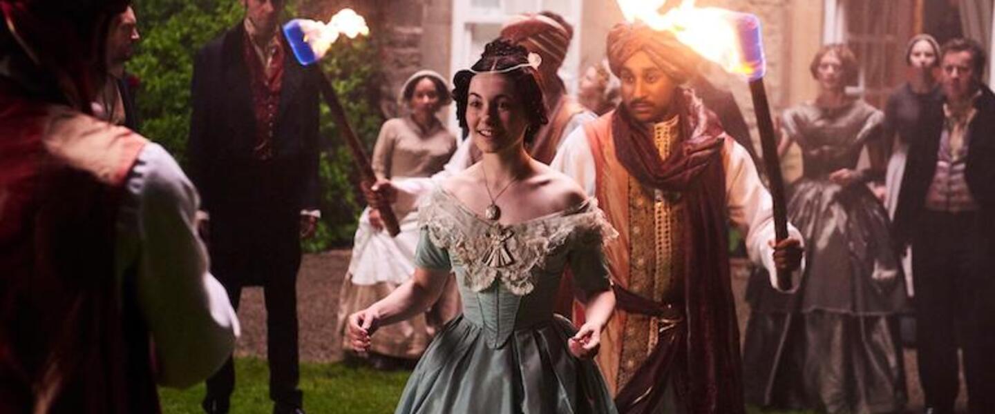 A woman at a night garden party.