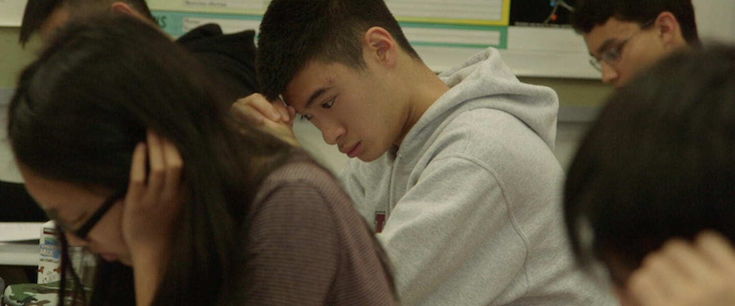 Students in a classroom taking a test.