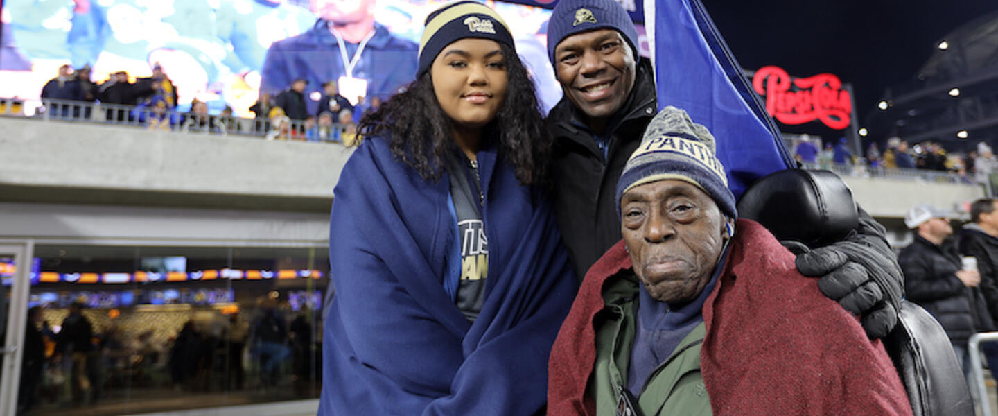 A girl with her father and grandfather.