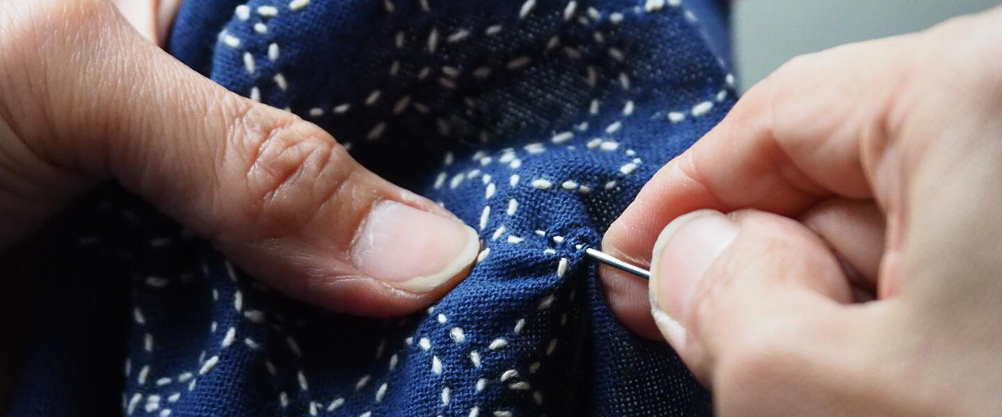 close up shot of hands sewing