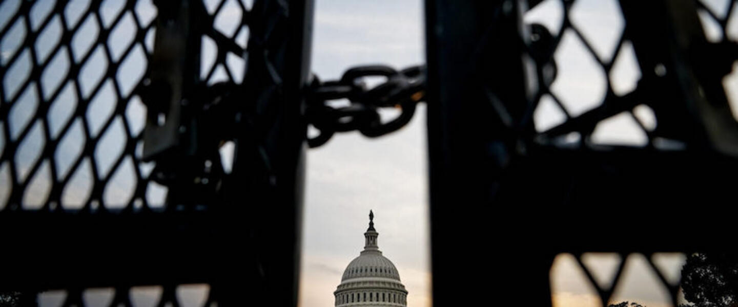 The capitol building behind a locked gate.