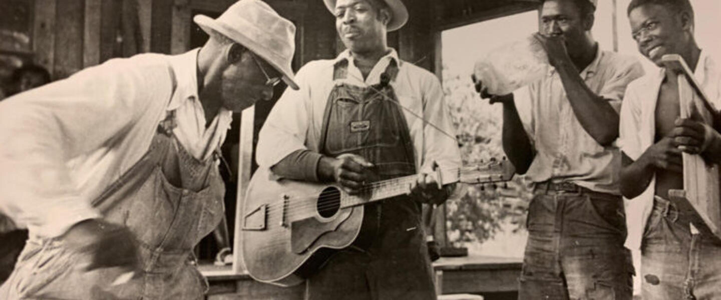 Four musicians in an old photograph.