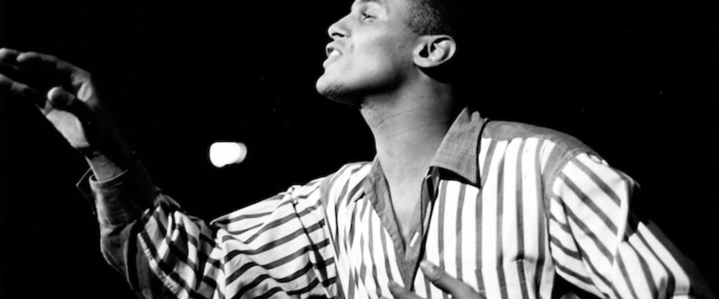 Harry Belafonte singing in a black and white picture.