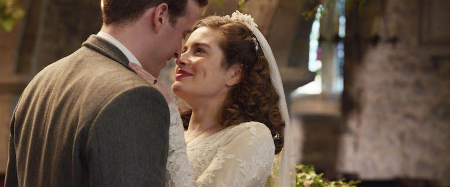 A man and woman embracing at a wedding.
