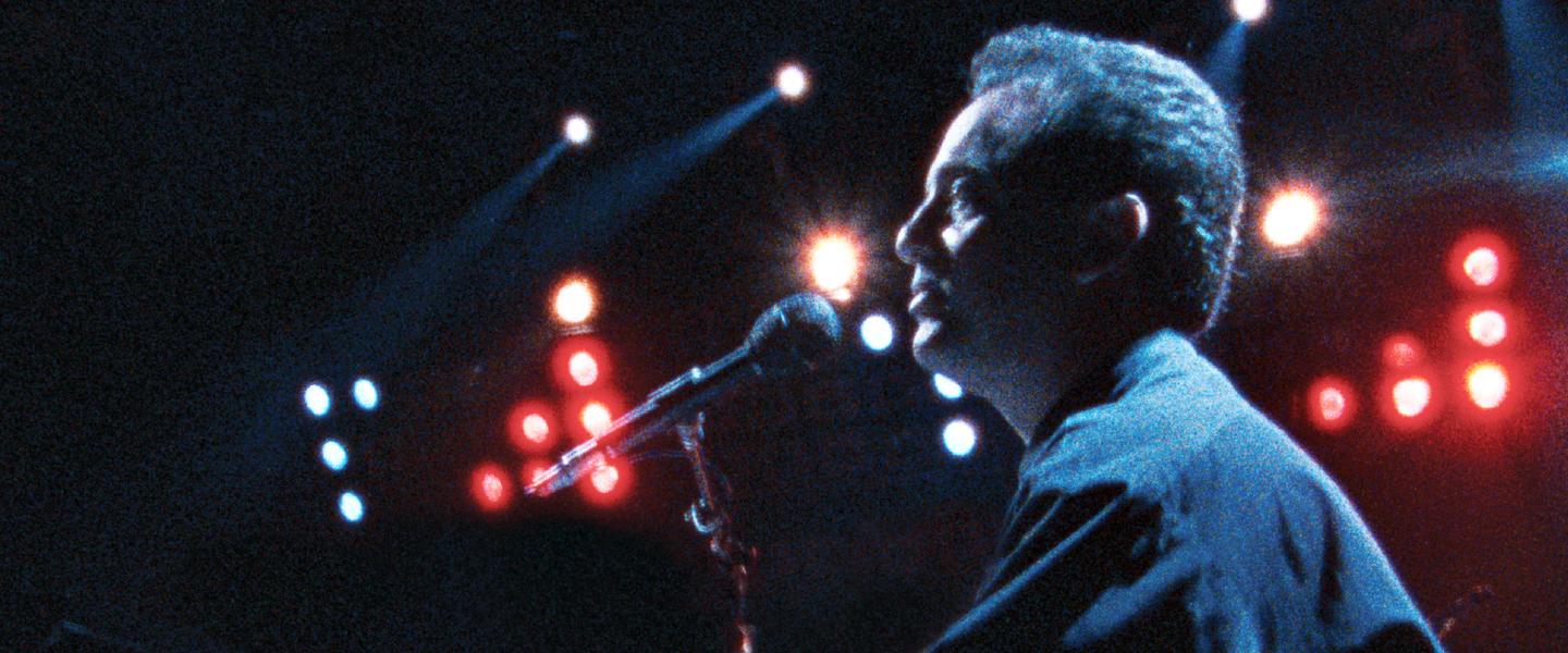 Billy Joel performing at his 1990 concert at Yankee Stadium in The Bronx.