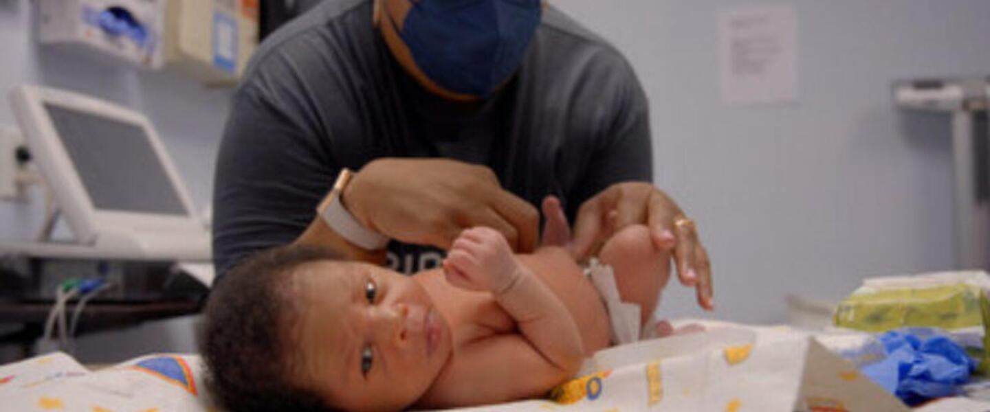 A doctor doing a check-up on an infant.