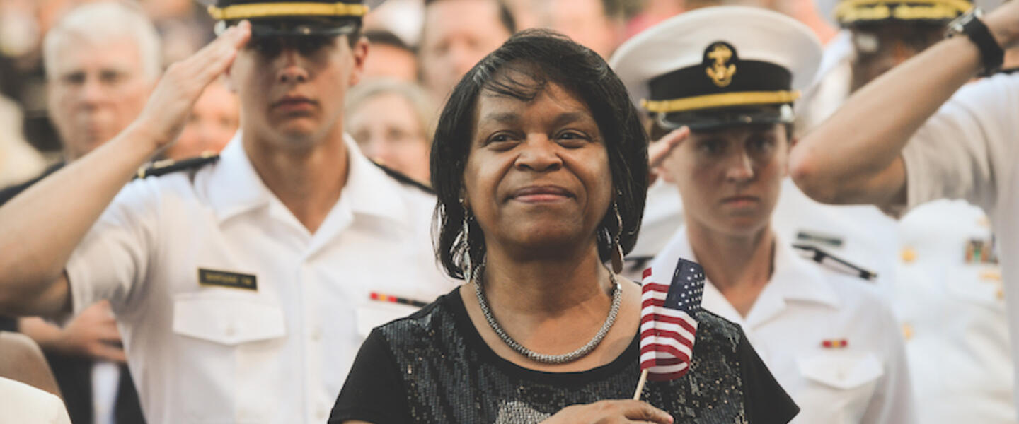 A woman with a flag stands.
