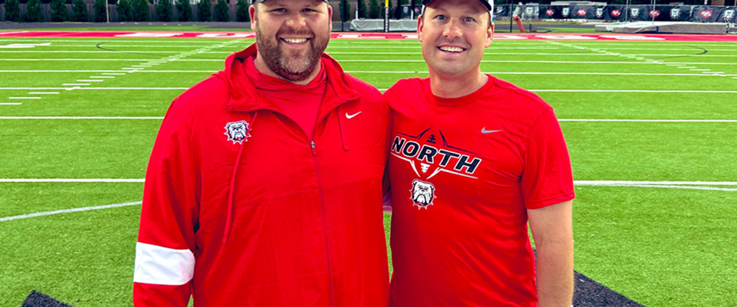 New North Gwinnett High School football coach Eric Godfree (right) and offensive line coach Nick Johnson (left) during the Bulldogs spring practice in May.