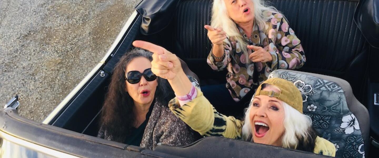 Members of the band Fanny in a convertable.