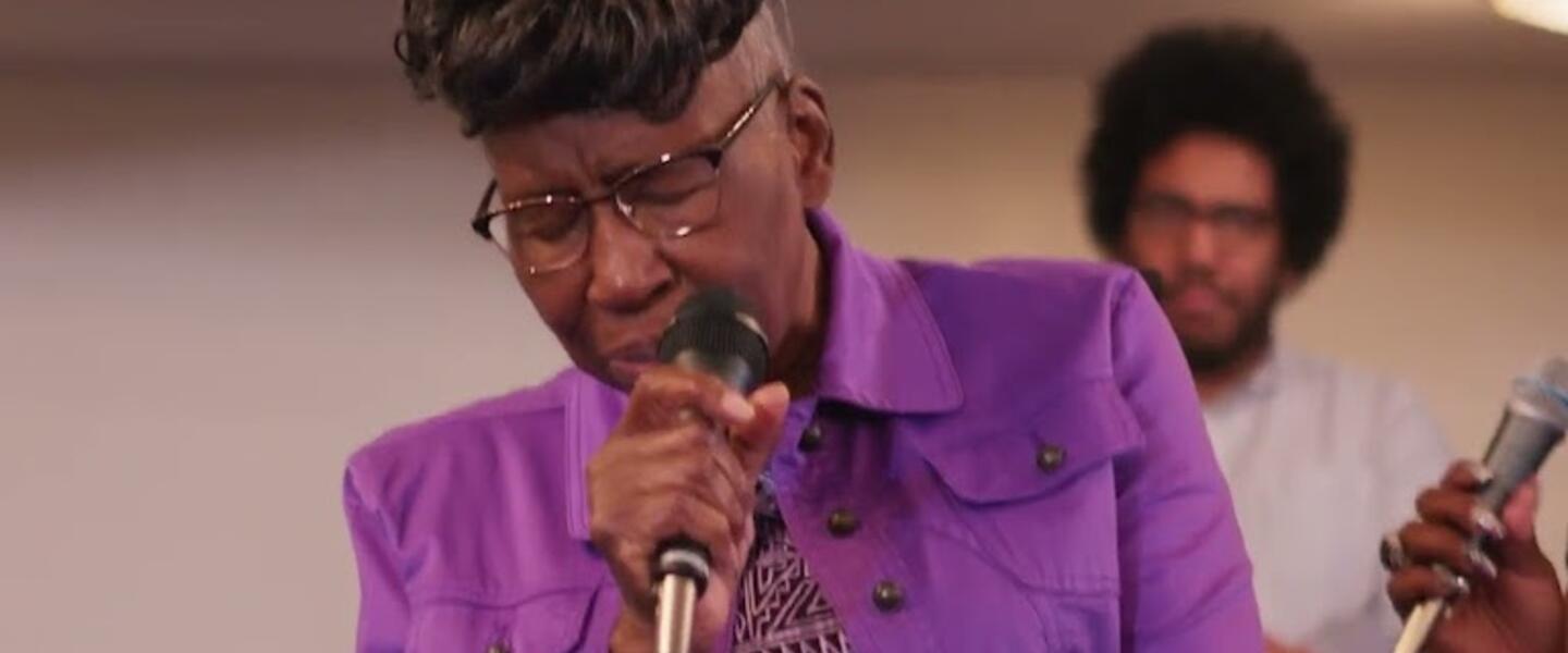 A woman on stage singing.