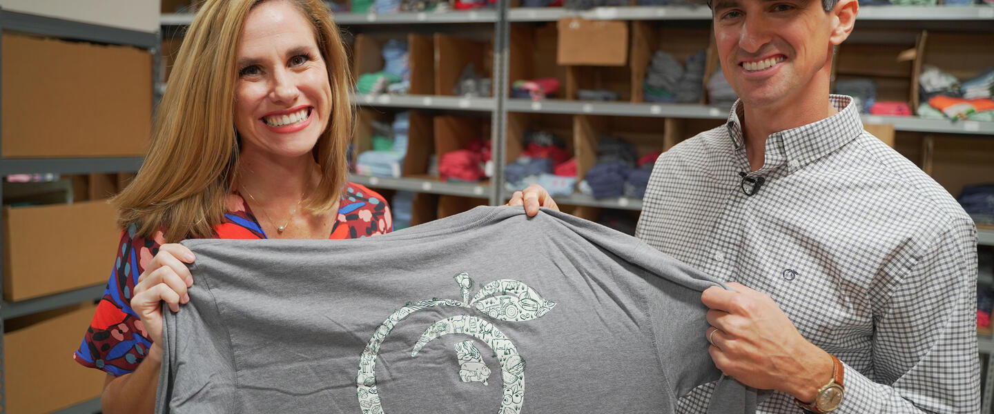 Derek and Kari Chitwood of Peach State Pride show off one of their shirts