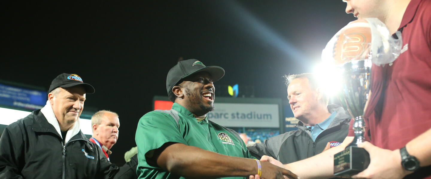 Hughes head Coach Boone Williams (right) and GPB reporter Jon Nelson after the Panthers won the 2022 GHSA 6A State Championship at Center Parc Stadium.