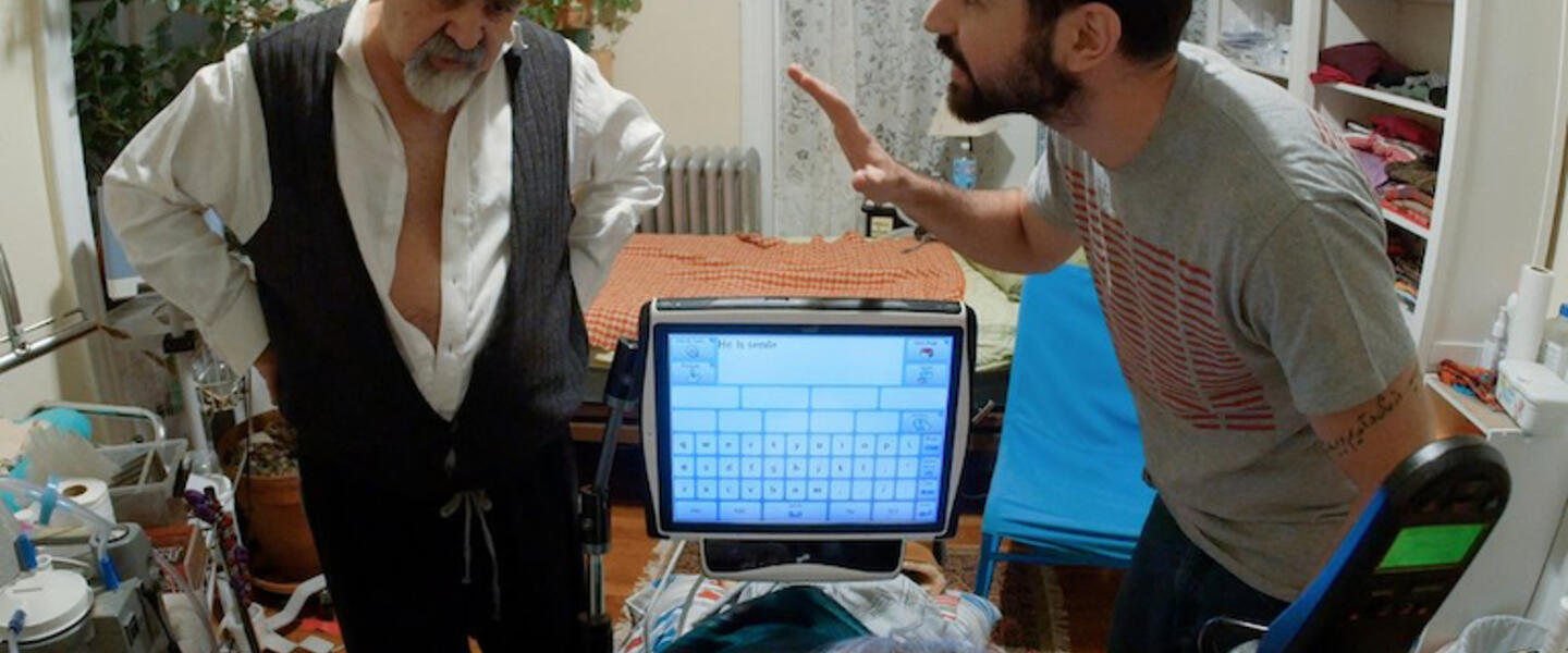 Two men argue over a woman in a wheelchair.