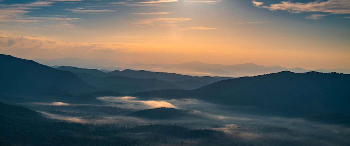 A picture of the sun rising over the Blue Ridge mountains.