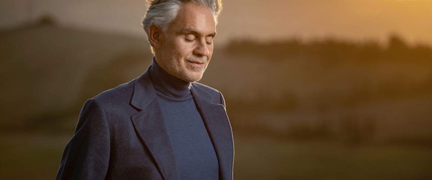 Andrea Bocelli standing outdoors.