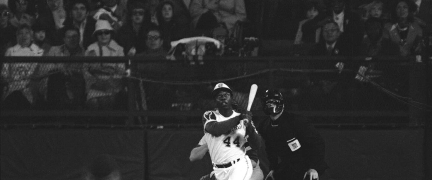 Atlanta Braves' Hank Aaron eyes the flight of the ball after hitting his 715th career homer in a game against the Los Angeles Dodgers in Atlanta, Ga., Monday night, April 8, 1974. Aaron broke Babe Ruth's record of 714 career home runs. Dodgers southpaw pitcher Al Downing, catcher Joe Ferguson and umpire David Davidson look on. Just in time for the 50-year anniversary of Hank Aaron's record 715th home run, Charlie Russo is making available video he shot of the homer. 