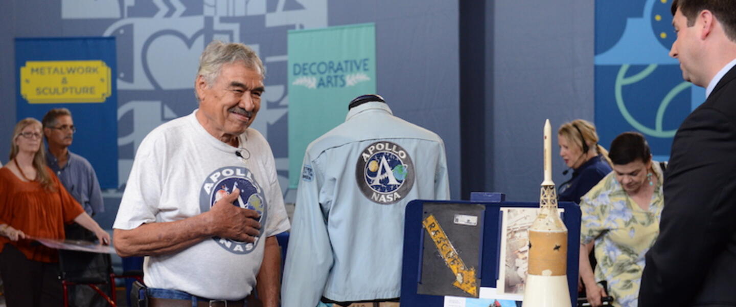 An older man getting NASA memorabilia appraised at the Antiques Roadshow.