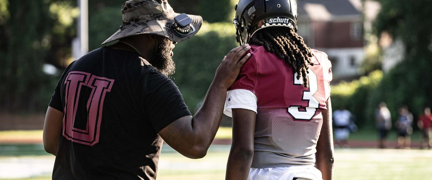 Utopian Academy head coach with a player