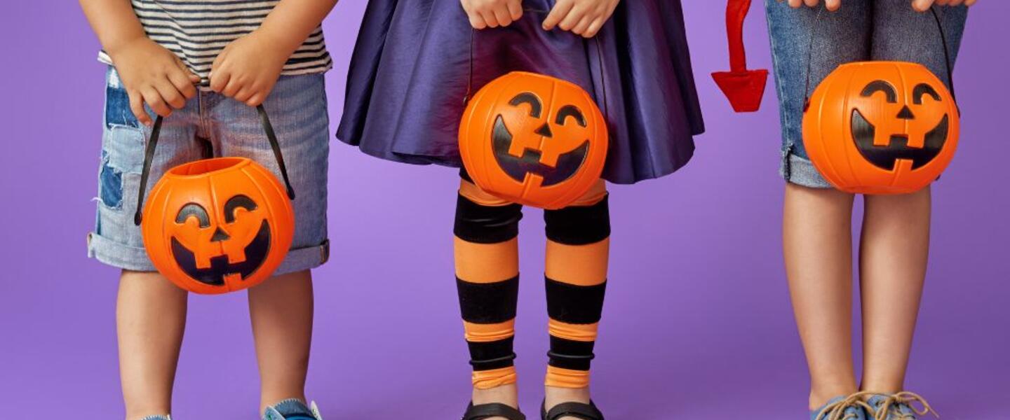 Three children with jack-o-lanterns.