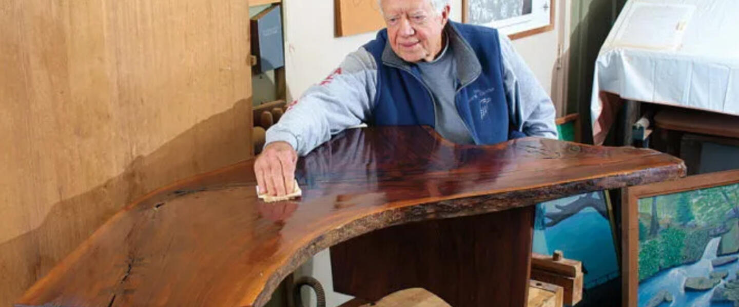 Jimmy Carter polishing furniture.