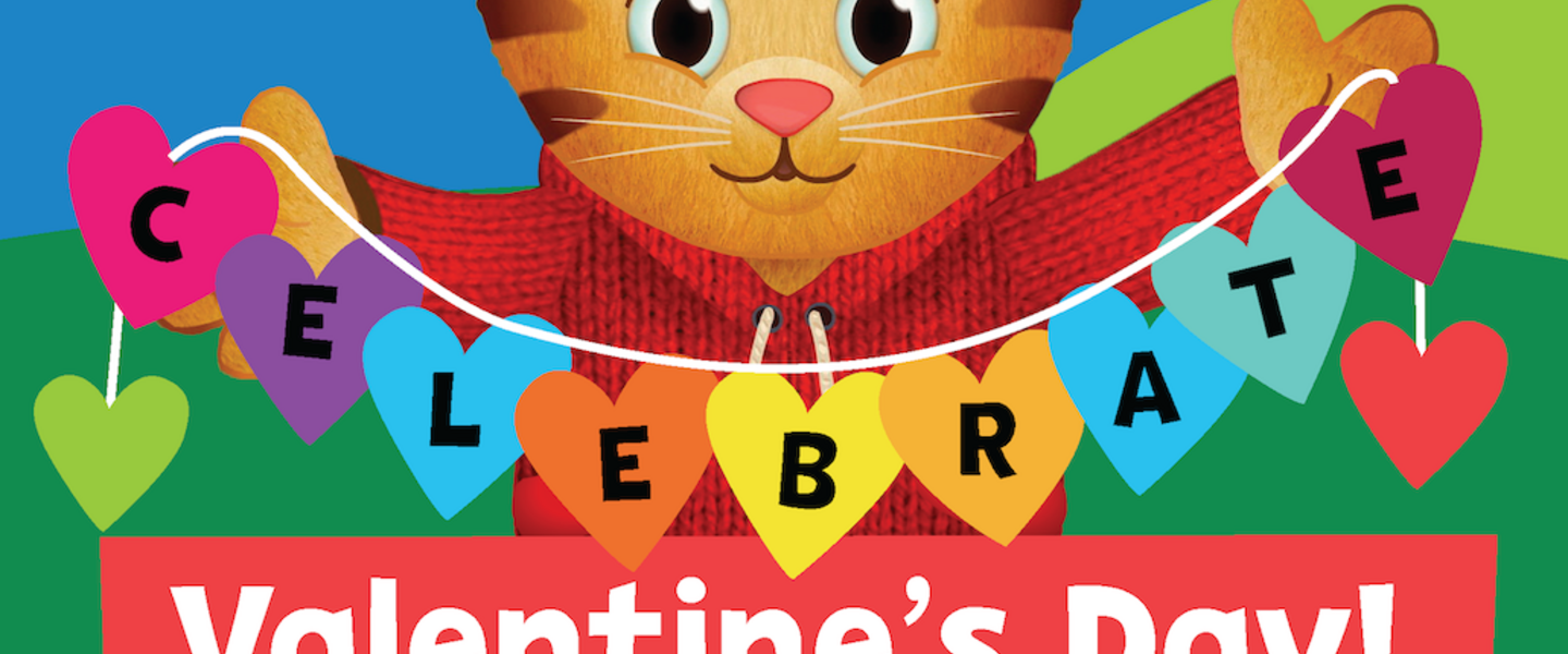 Daniel Tiger holds up a paper heart string that says "Celebrate Valentine's Day!"